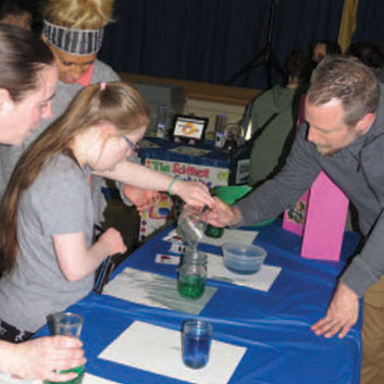 Larc School Science Fair 2018 - student puring liquid with teacher