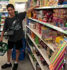 Male Larc student selecting items in a supermarket