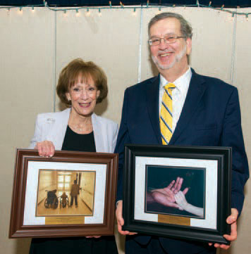 Susan Weiner, left, and Ross Angilella, right receiving awards