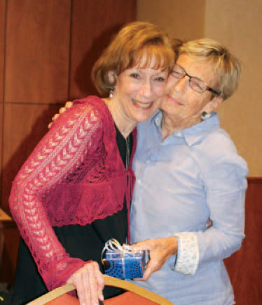 Executive Director Susan Weiner and Pre Vocational Teacher Dianne Bentliff embrace after Dianne receives a retirement gift and is honored for her 38 years with Larc School.