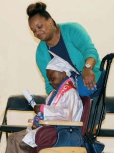 Preschool graduate Jamal admires his diploma and celebrates this special milestone.